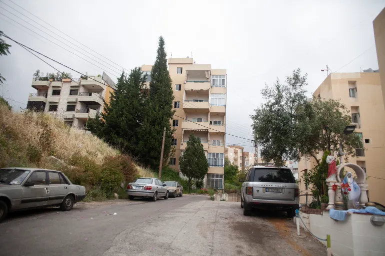 Chadi is able to see his parents' home from his apartment block [Tessa Fox/Al Jazeera]